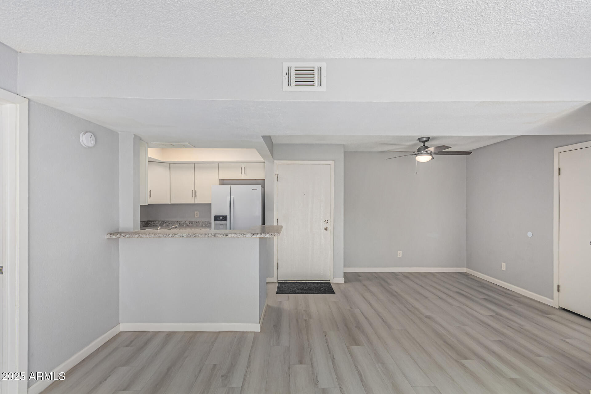 4730 West Northern Avenue, Unit 1087 Glendale, AZ 85301 - Photo 10 of 34 a view of a kitchen with wooden floor and a sink