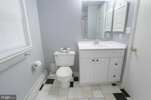 a bathroom with a toilet sink and mirror