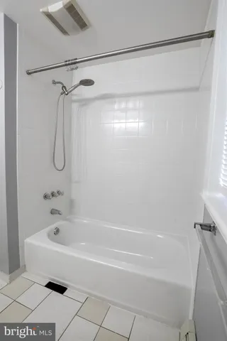 a bathroom with a shower and a bath tub
