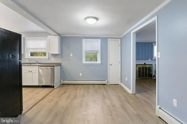 a view of a kitchen with a sink cabinet and a window