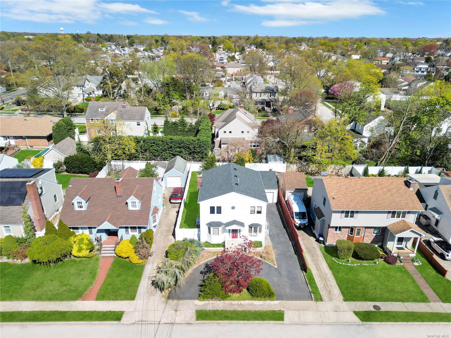 an aerial view of residential houses with yard