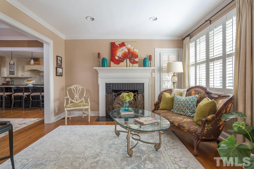 3104 Georgian Terrace Raleigh, NC 27607 - Photo 2 of 25 a living room with furniture a lamp and a fireplace