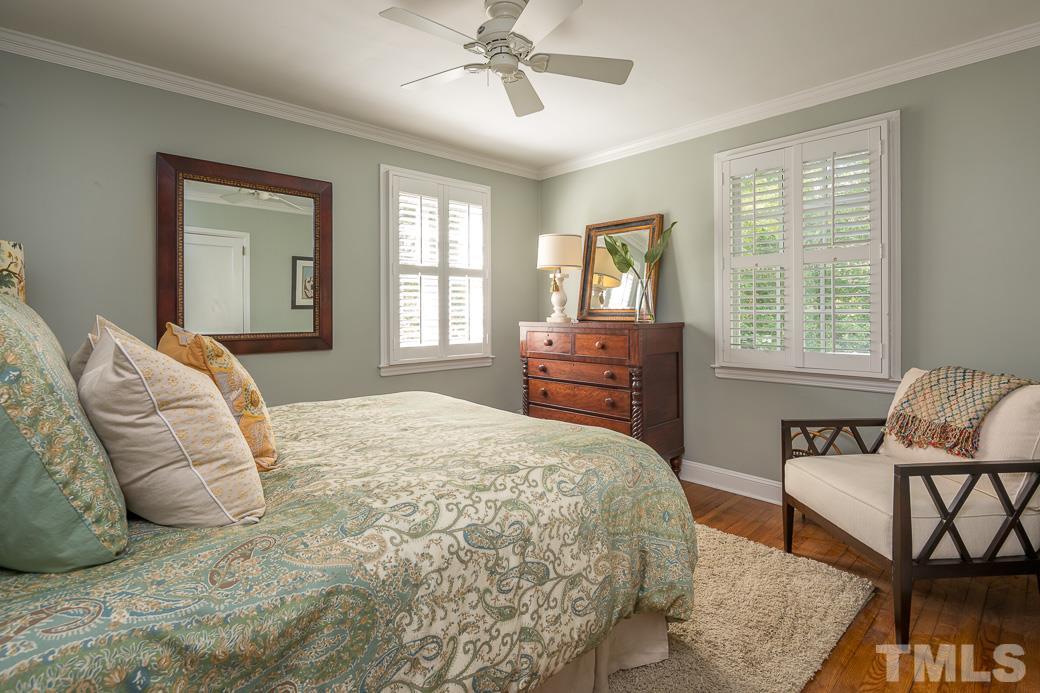 3104 Georgian Terrace Raleigh, NC 27607 - Photo 13 of 25 a bedroom with a large bed and windows