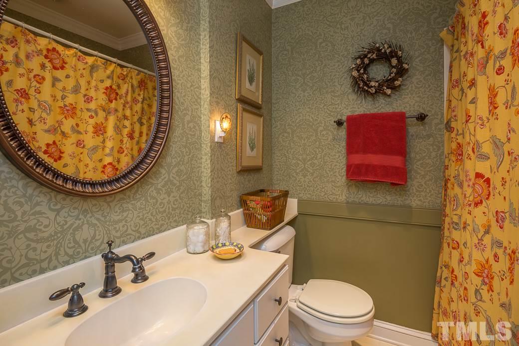 3104 Georgian Terrace Raleigh, NC 27607 - Photo 16 of 25 a bathroom with a sink a toilet and a mirror
