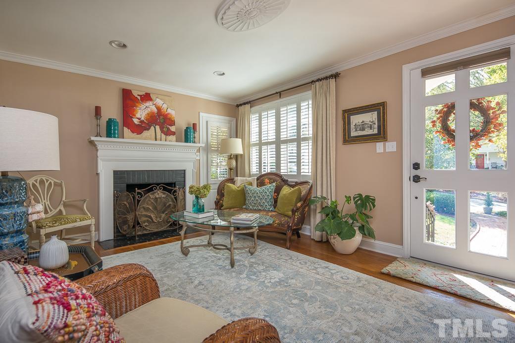 3104 Georgian Terrace Raleigh, NC 27607 - Photo 3 of 25 a living room with furniture window and a fireplace