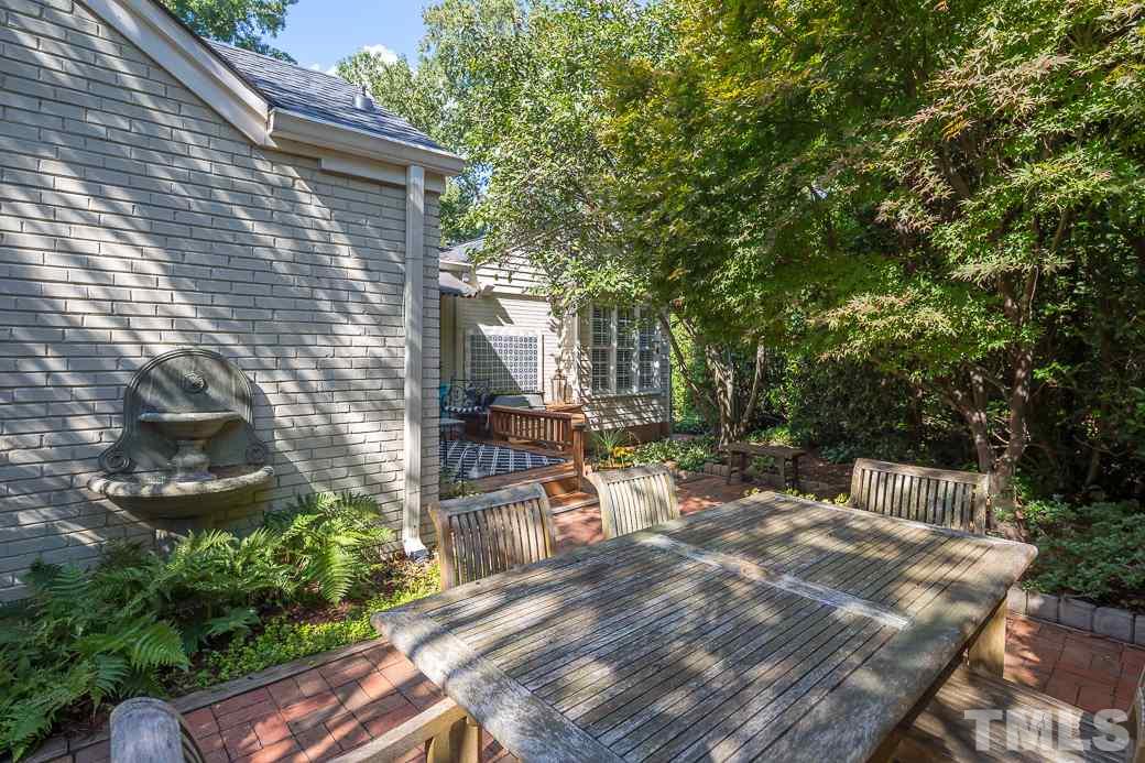 3104 Georgian Terrace Raleigh, NC 27607 - Photo 22 of 25 a view of backyard with a table and chairs and potted plants