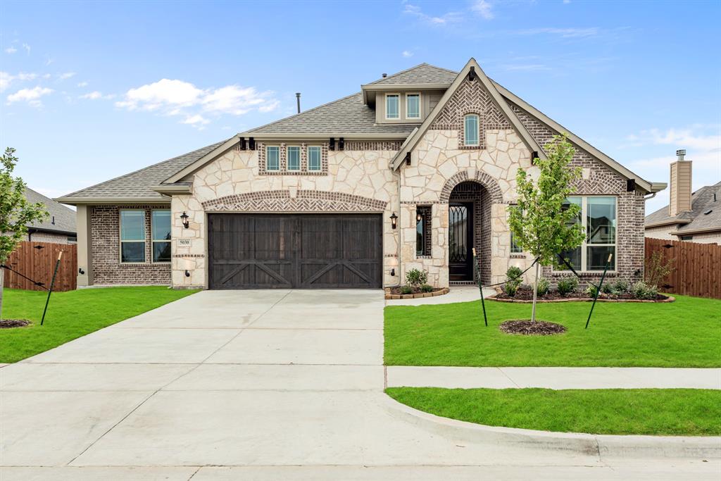 a front view of a house with a garden and patio