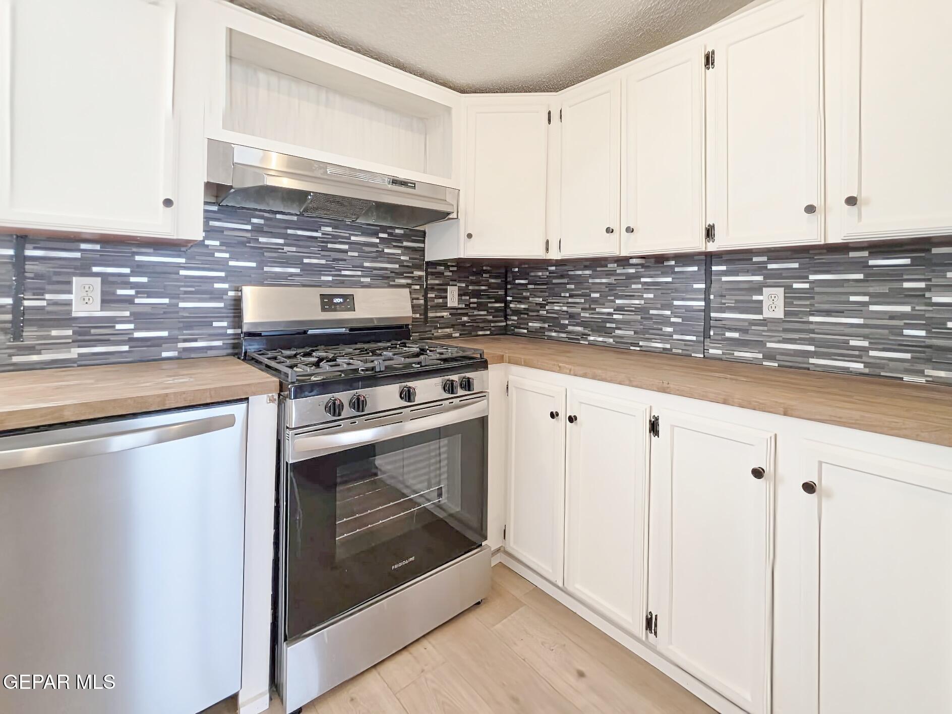 101 Clydesdale Road Dell City, TX 79847 - Photo 25 of 90 a kitchen with granite countertop white cabinets and white appliances