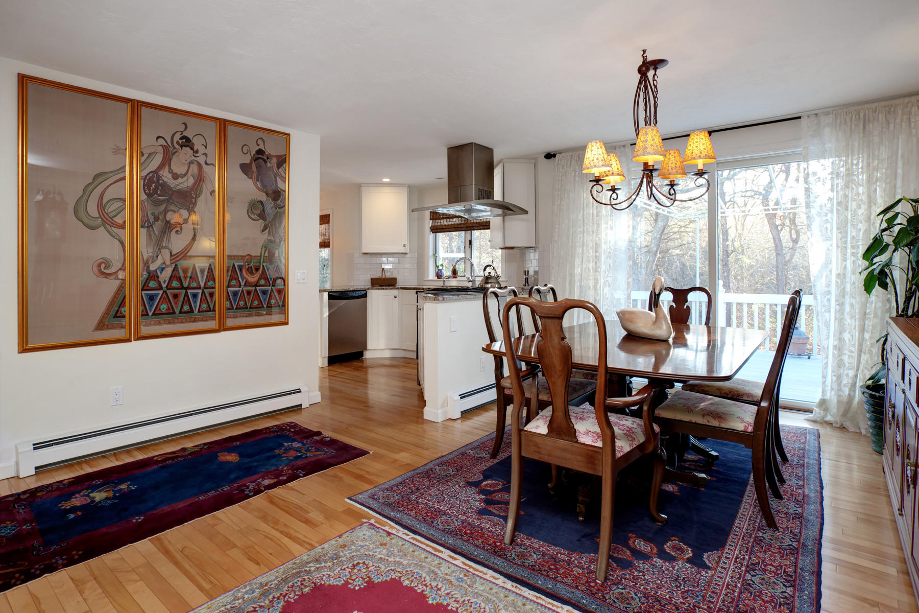 47 Meadowbrook Road Mashpee, MA 02649 - Photo 8 of 31 a dining room with wooden floor a chandelier a wooden table and chairs