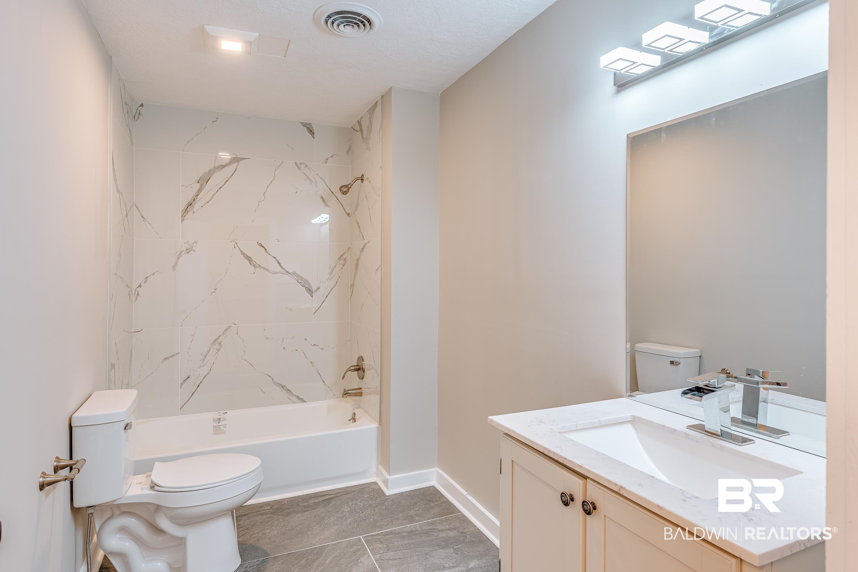 8001 16th Street Irvington, AL 36544 - Photo 19 of 35 Full bath with shower / washtub combination, vanity, and light tile patterned floors