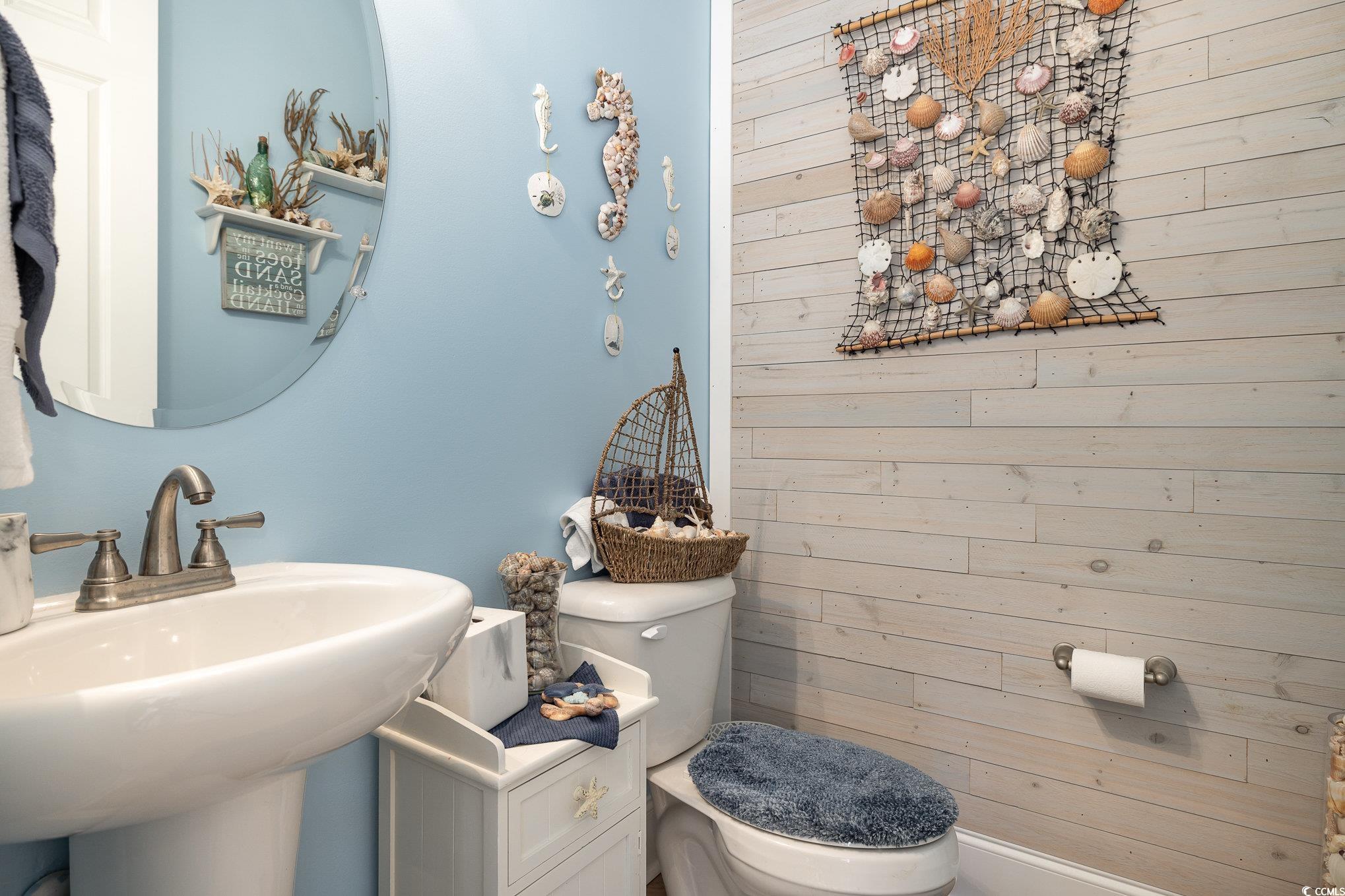 839 Rosa Circle Myrtle Beach, SC 29577 - Photo 22 of 40 Bathroom with wood walls, sink, and toilet