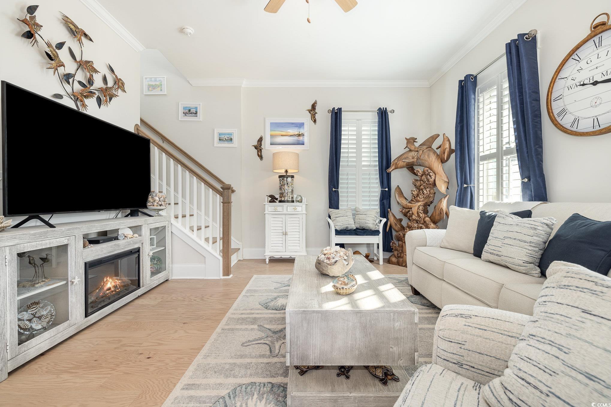 Living room featuring light wood-type flooring, ce