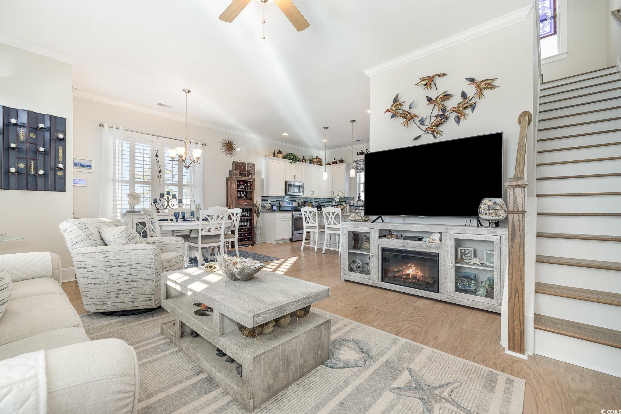Living room featuring ceiling fan with notable cha