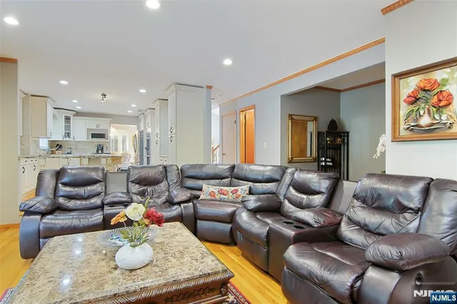 a living room with furniture kitchen and a table
