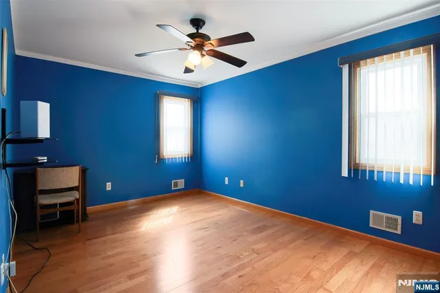 a view of a room with a window and a ceiling fan