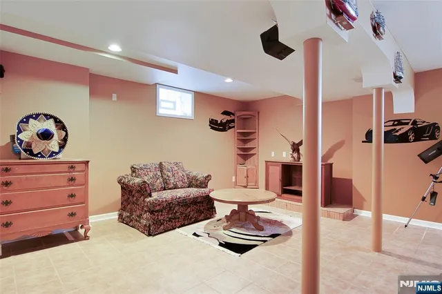 a living room with furniture and a ceiling fan