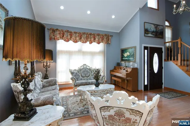 a living room with furniture fireplace and a large window