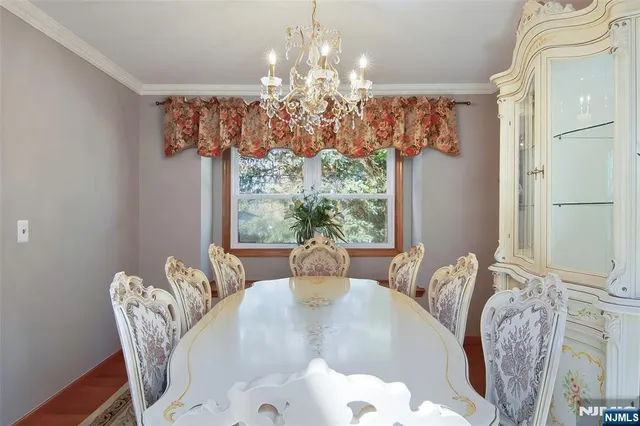 a dining room with furniture a chandelier and window