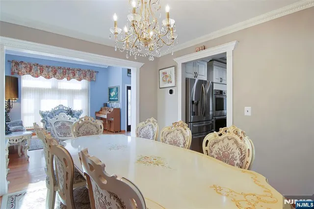 a view of a dining room with furniture and chandelier