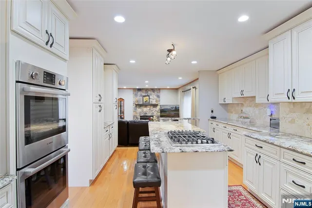 a kitchen with a refrigerator and a stove top oven