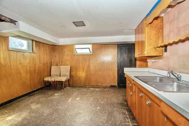 a kitchen with a sink and a refrigerator