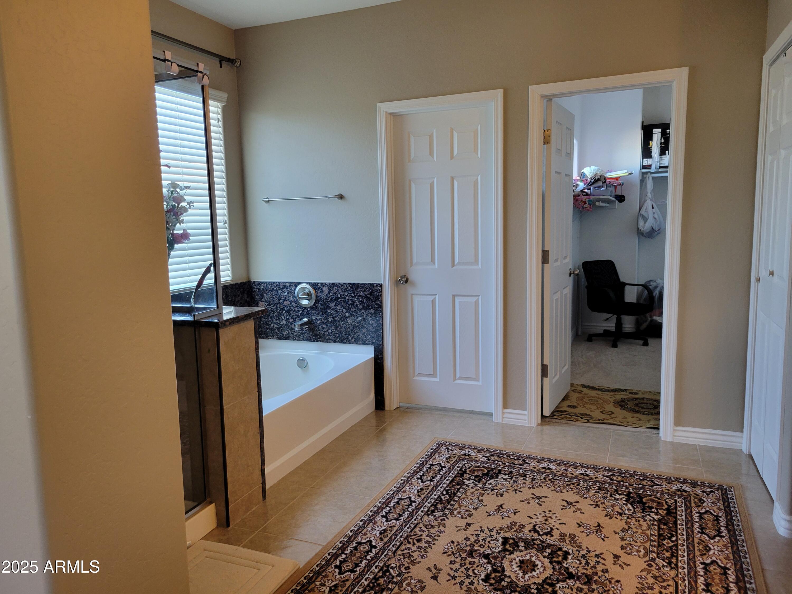 7439 West Wolf Street Phoenix, AZ 85033 - Photo 12 of 21 a view of a hallway to closet and a couch