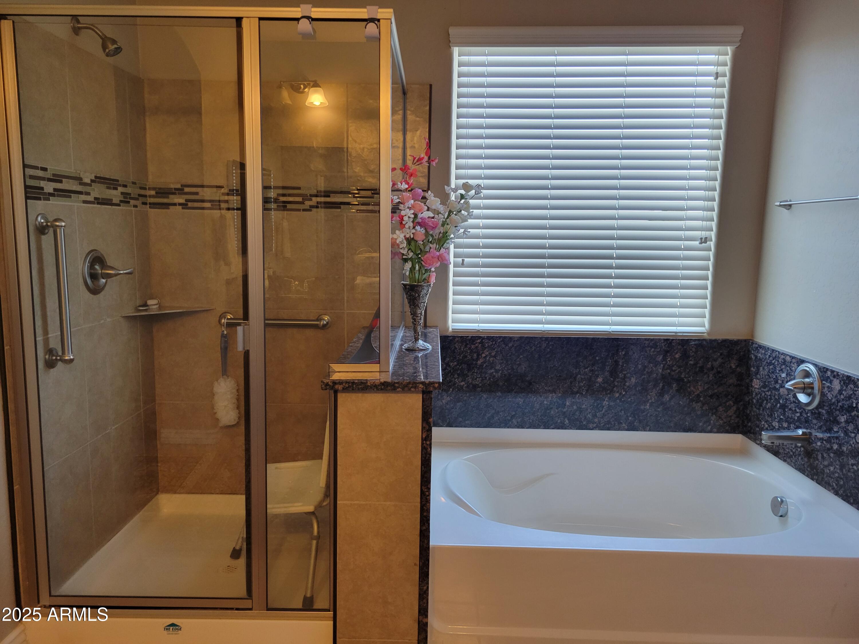 7439 West Wolf Street Phoenix, AZ 85033 - Photo 13 of 21 a bathroom with a bathtub and a shower
