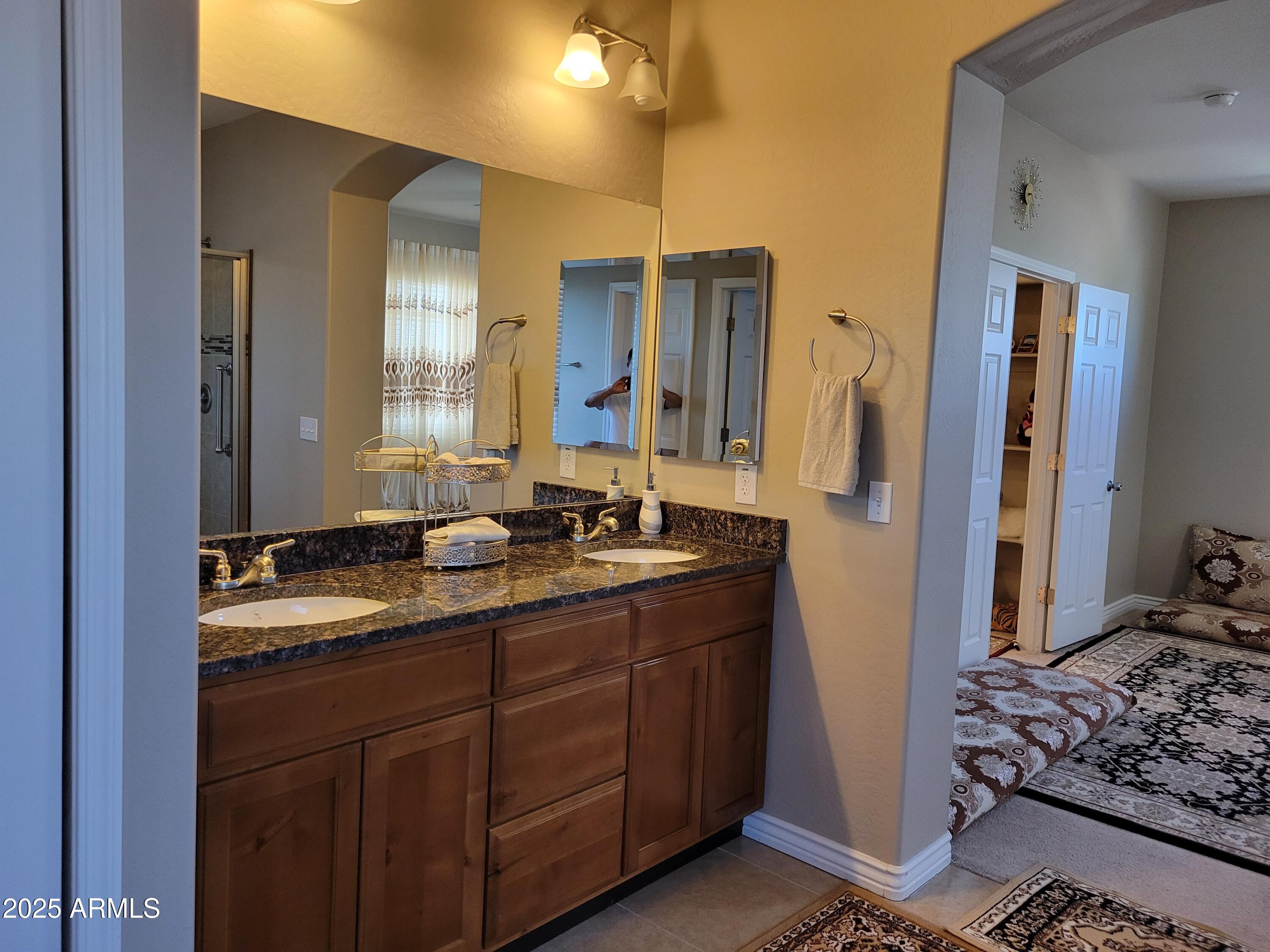 7439 West Wolf Street Phoenix, AZ 85033 - Photo 14 of 21 a bathroom with a sink and a mirror