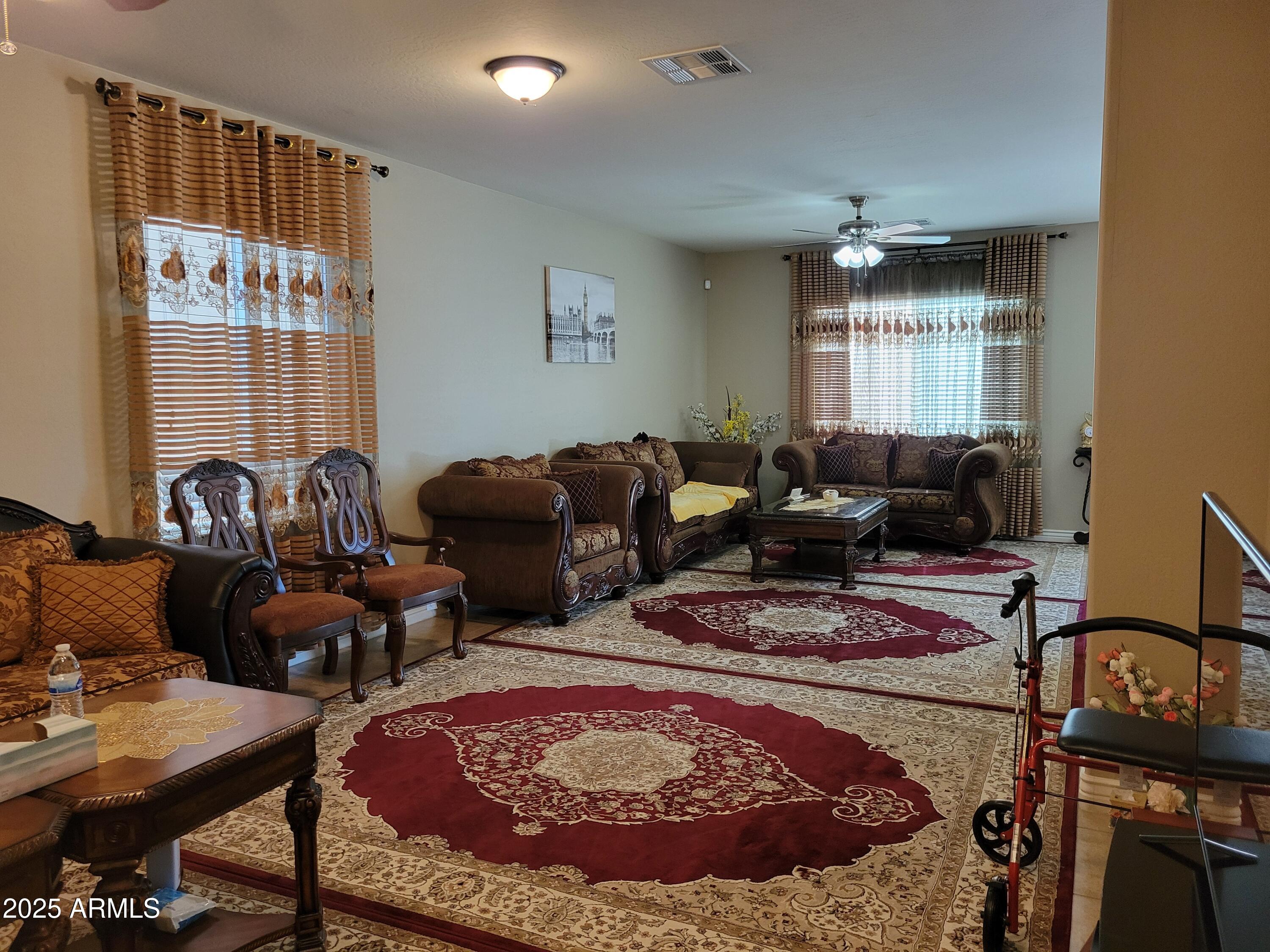 7439 West Wolf Street Phoenix, AZ 85033 - Photo 4 of 21 a living room with furniture a rug and a window