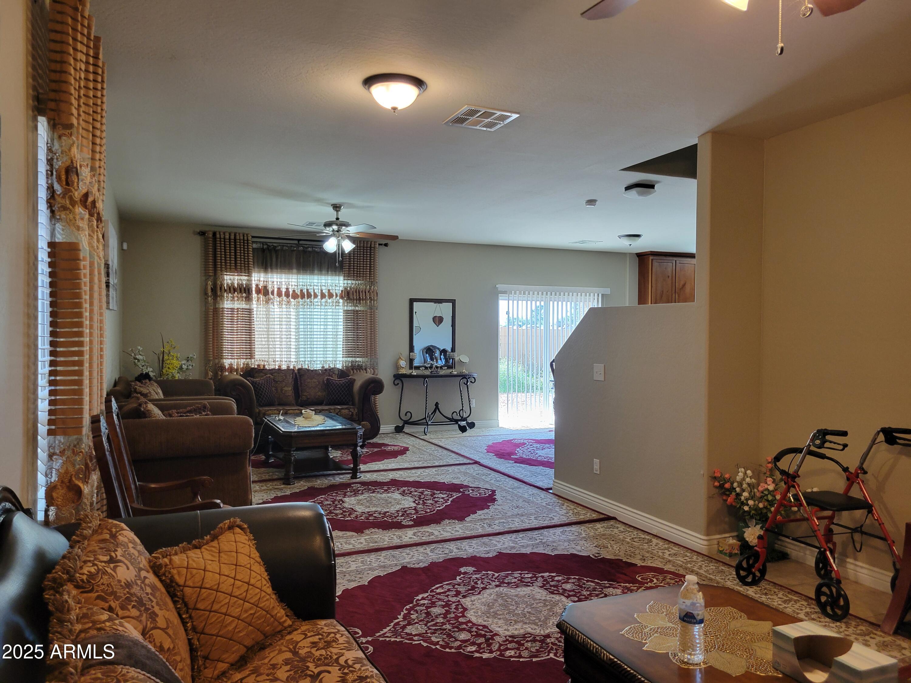 7439 West Wolf Street Phoenix, AZ 85033 - Photo 5 of 21 a living room with furniture and a potted plant