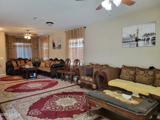 a living room with furniture wooden floor and window