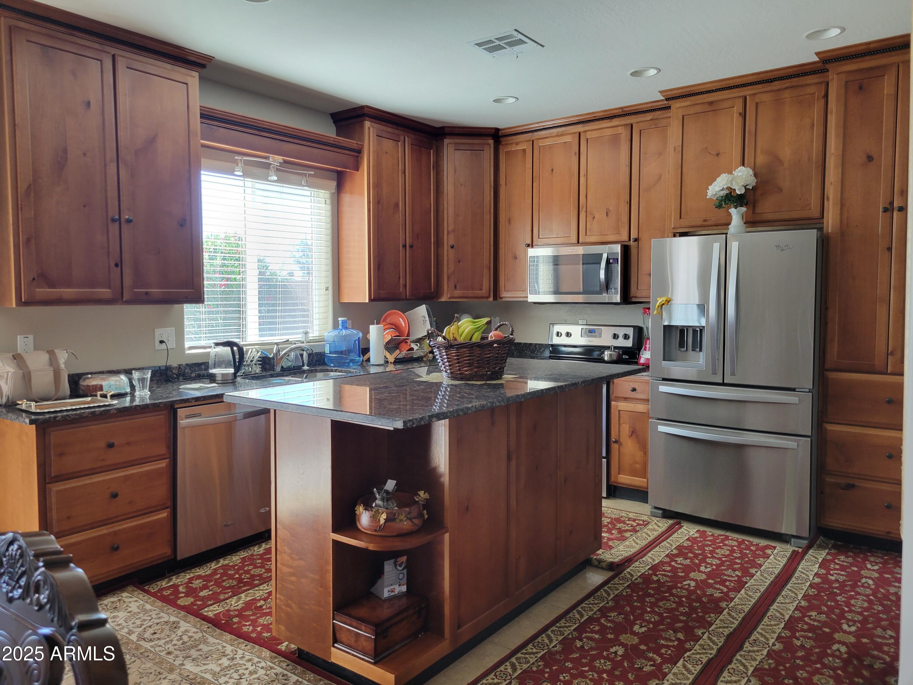 7439 West Wolf Street Phoenix, AZ 85033 - Photo 10 of 21 a kitchen with stainless steel appliances granite countertop a refrigerator stove and sink