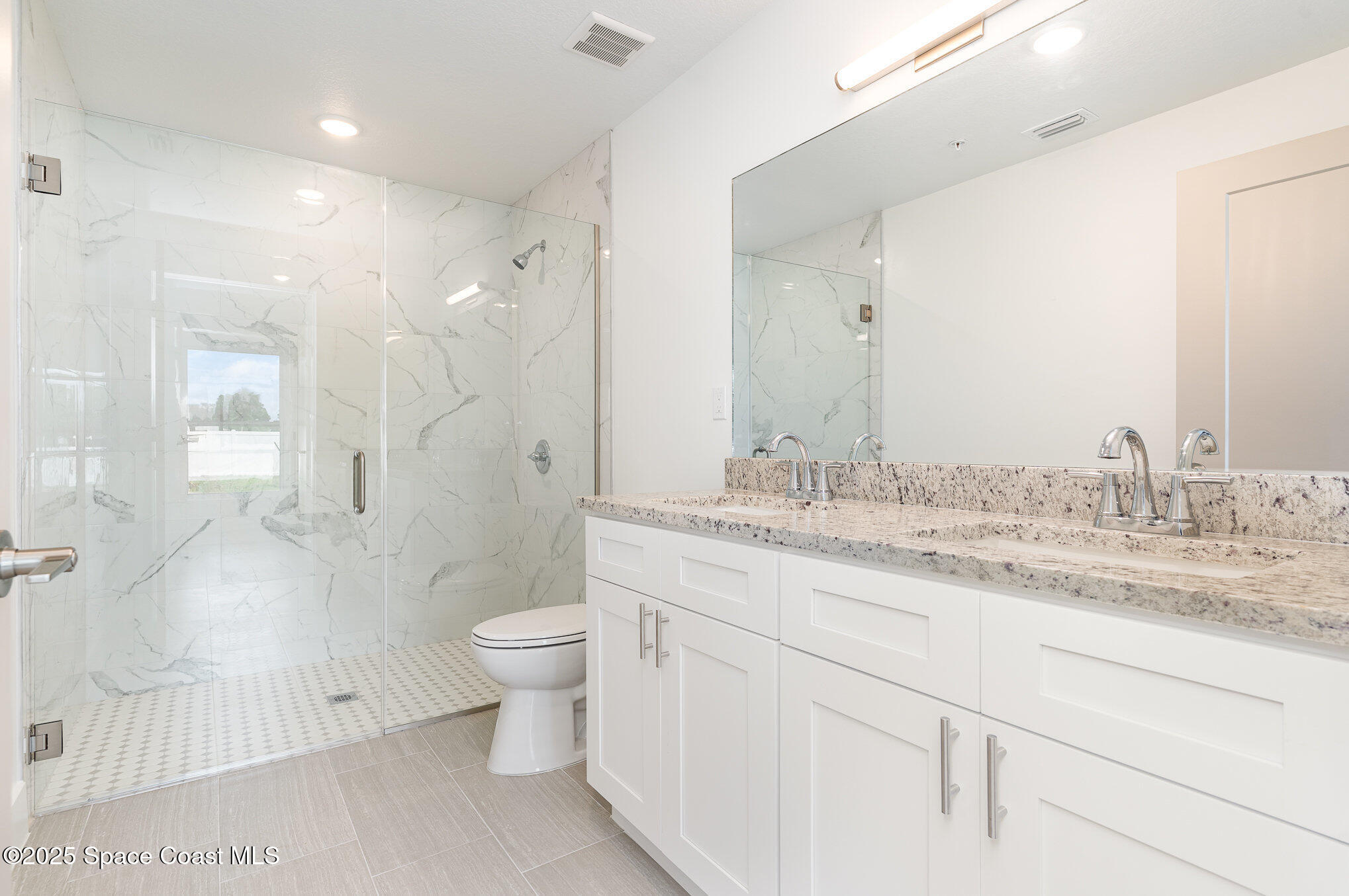 1635 Par Street Northeast, Unit 2103 Palm Bay, FL 32905 - Photo 15 of 36 a bathroom with a granite countertop sink mirror and toilet