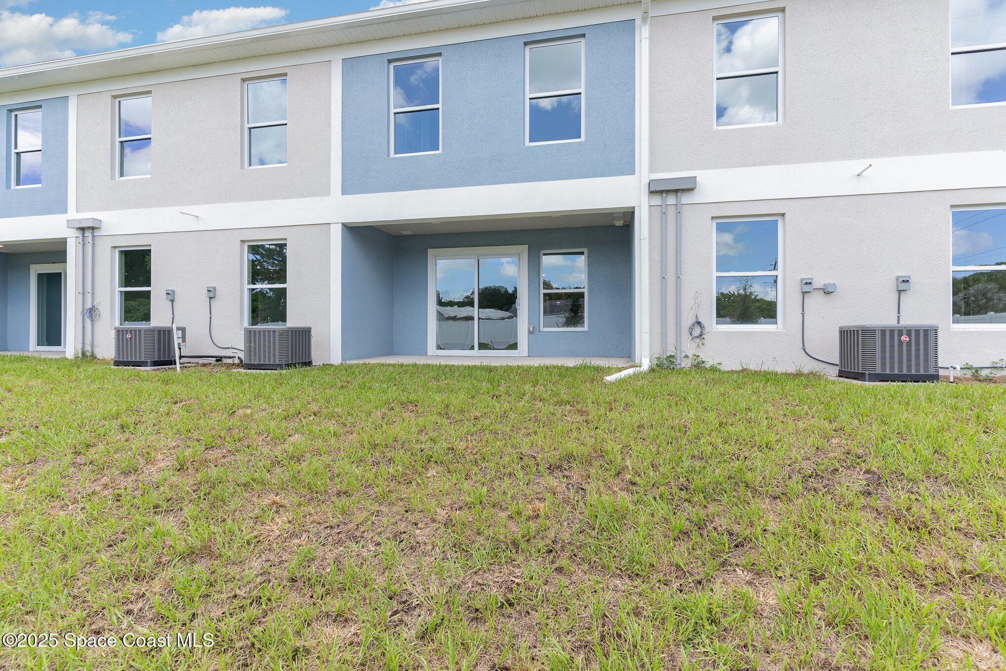1635 Par Street Northeast, Unit 2103 Palm Bay, FL 32905 - Photo 33 of 36 a large building with a garden in front of it