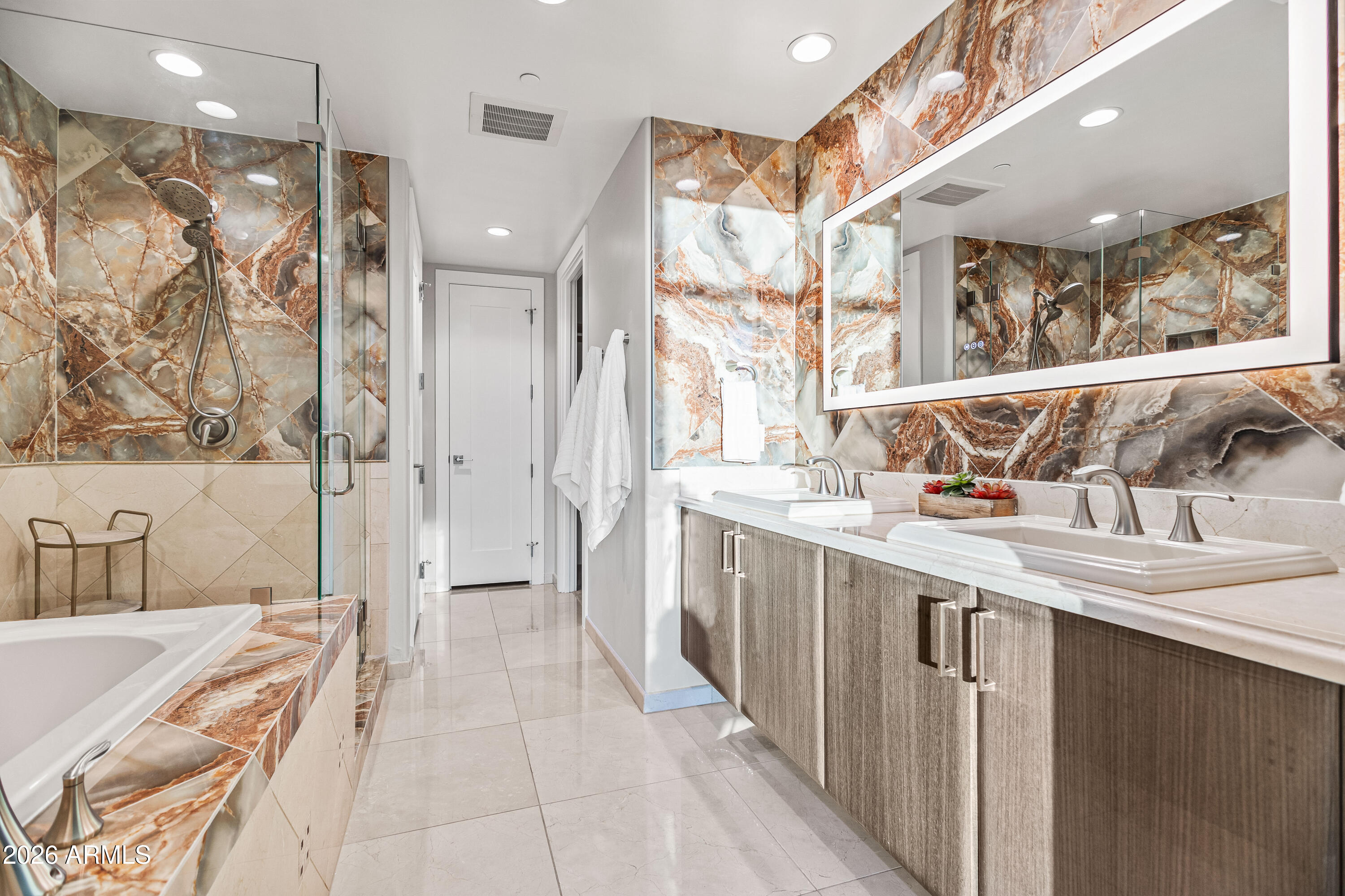 140 East Rio Salado Parkway, Unit 1101 Tempe, AZ 85281 - Photo 13 of 32 a bathroom with a double vanity sink a large mirror and a bathtub