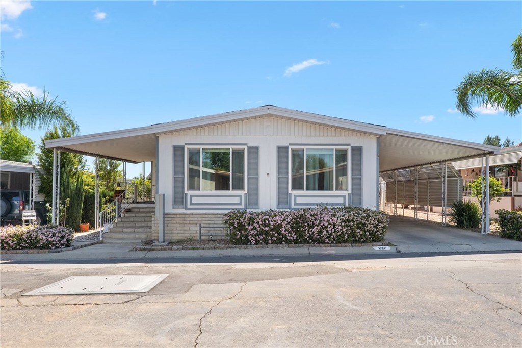 27701 Murrieta Road, Unit 227 Menifee, CA 92586 - Photo 1 of 36 a front view of a house with a garden