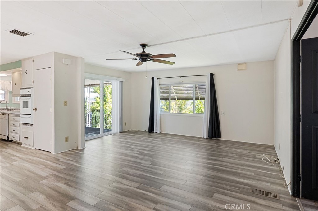 27701 Murrieta Road, Unit 227 Menifee, CA 92586 - Photo 12 of 36 an empty room with wooden floor and windows