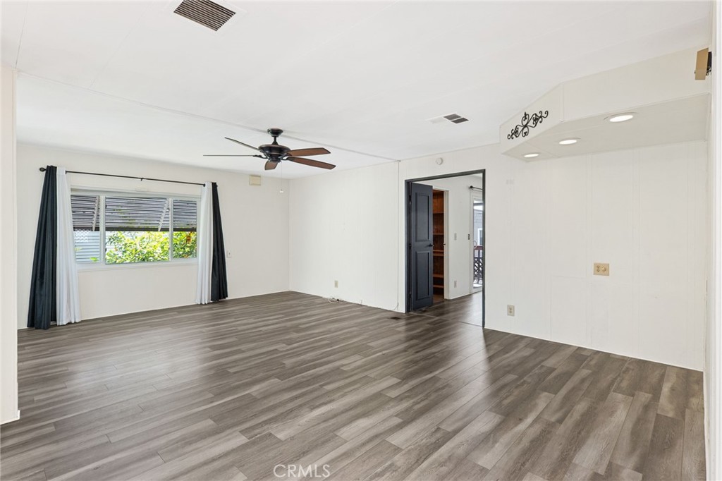27701 Murrieta Road, Unit 227 Menifee, CA 92586 - Photo 14 of 36 a view of an empty room with window and wooden floor