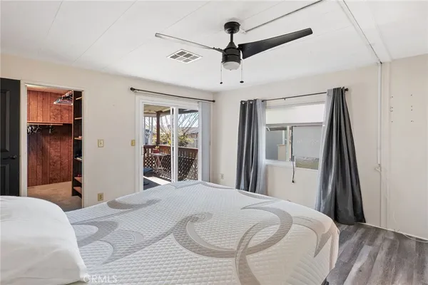 a bedroom with a bed and a large mirror with a flat tv screen