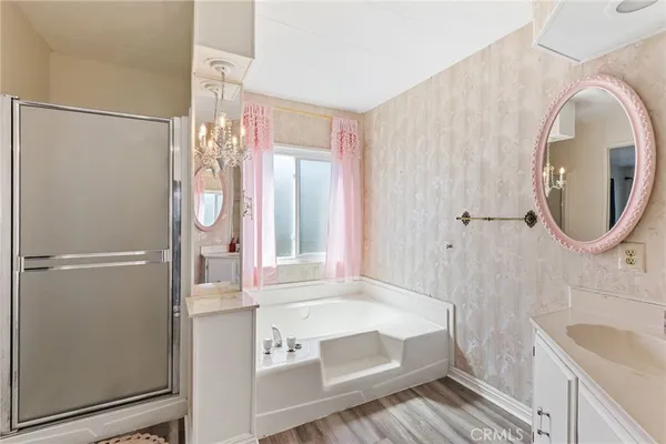 a bathroom with a tub a sink and mirror