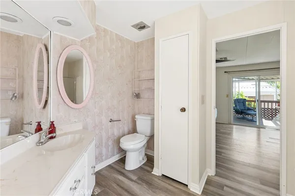 a bathroom with a sink toilet a mirror and vanity