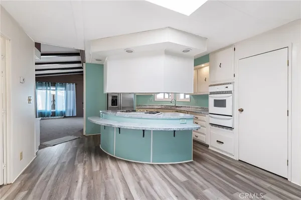 a kitchen with stainless steel appliances granite countertop a stove and a refrigerator