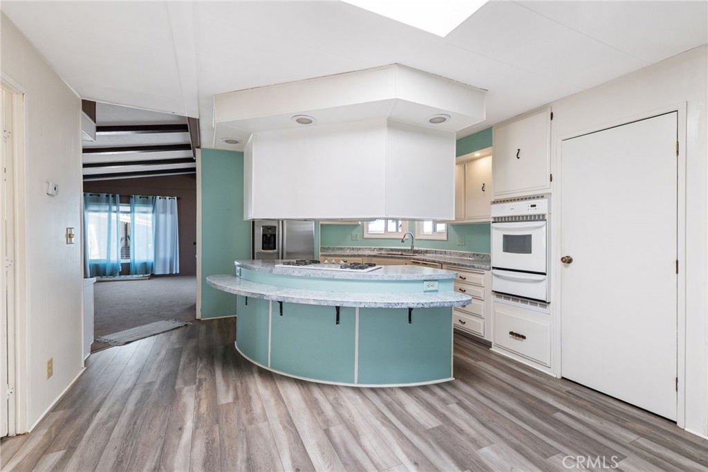 27701 Murrieta Road, Unit 227 Menifee, CA 92586 - Photo 7 of 36 a kitchen with stainless steel appliances granite countertop a stove and a refrigerator