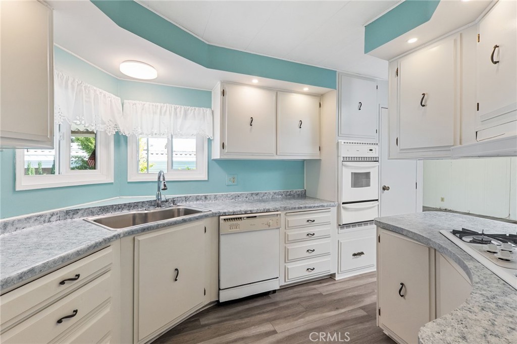 27701 Murrieta Road, Unit 227 Menifee, CA 92586 - Photo 8 of 36 a kitchen with granite countertop a sink stove and cabinets