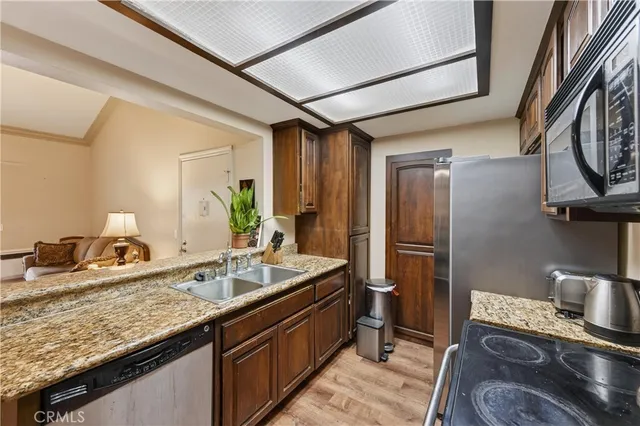 a kitchen with sink refrigerator and stove