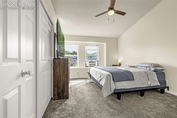 a bedroom with a bed couch and a window