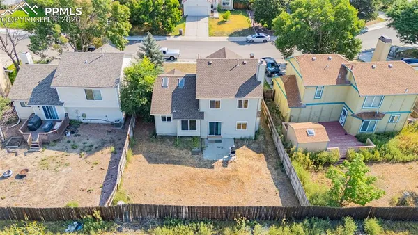 an aerial view of a house with a garden and yard