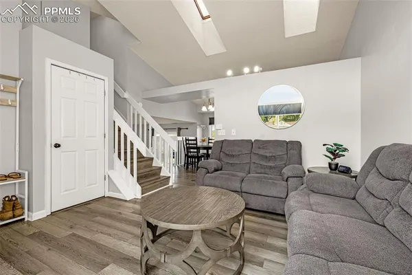 a living room with furniture and a wooden floor