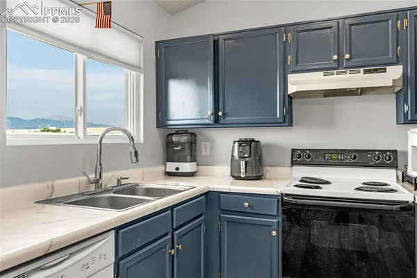 a kitchen with stainless steel appliances granite countertop a sink stove and cabinets