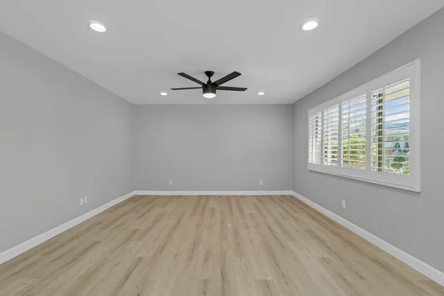 wooden floor in an empty room with a window